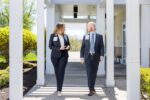 Dr. Wasser and Eleanor Cronley walking outside of Welcome Center
