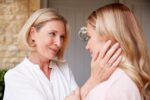 Mother comforting adult daughter